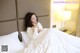 A woman laying on a bed in a hotel room.