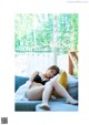 A woman laying on a couch with her legs crossed.